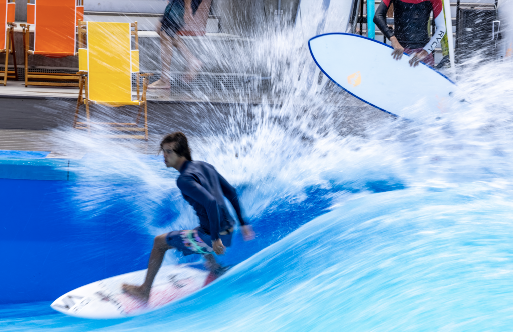 surfer carving wave and splashing spectators