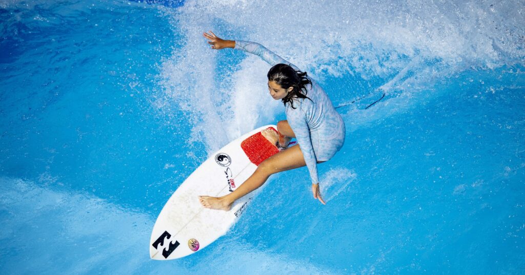 girl surfing standing wave